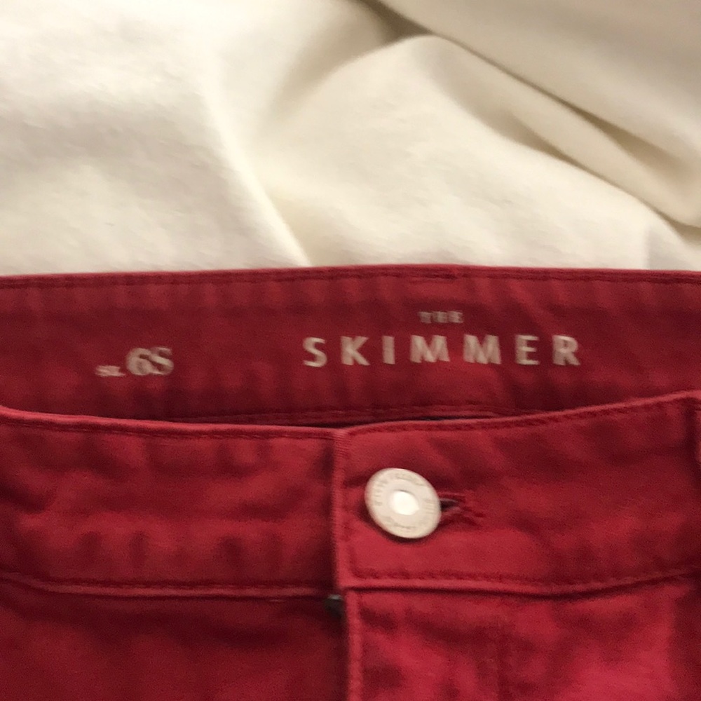 Red jeans with ankle zip detail. The Skimmer